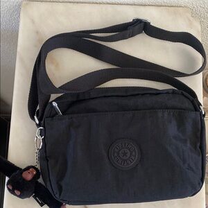 NWOT Kipling Black Messenger Bag with Adjustable Strap and Signature Charm